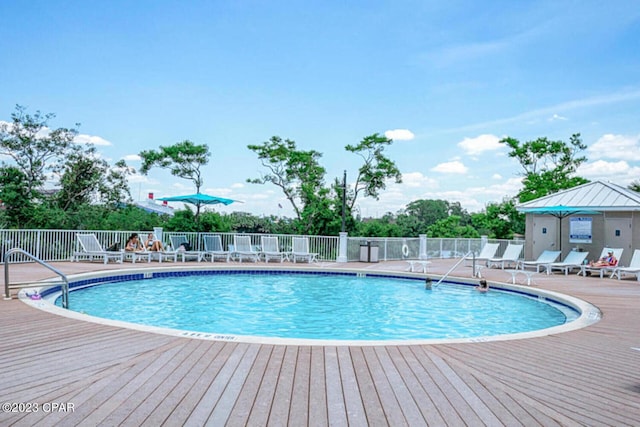 view of swimming pool featuring a wooden deck