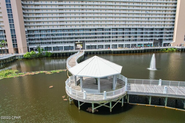 view of dock featuring a gazebo and a water view