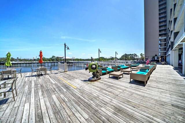 dock area featuring a deck with water view and an outdoor hangout area