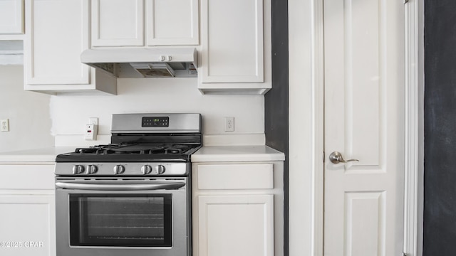 kitchen featuring gas range and white cabinets