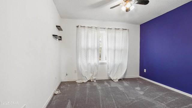 carpeted spare room with ceiling fan and a textured ceiling