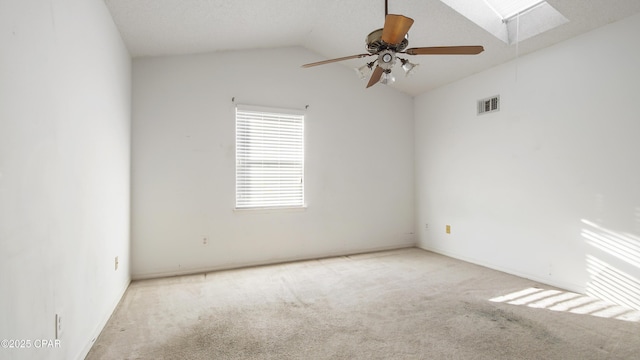 spare room with light carpet, ceiling fan, and vaulted ceiling