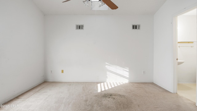 carpeted spare room with ceiling fan