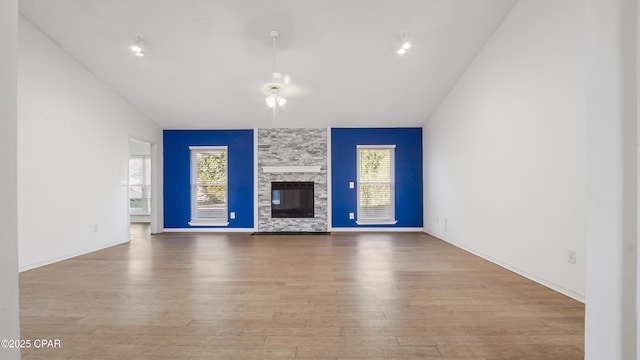 unfurnished living room with a fireplace, light hardwood / wood-style floors, and plenty of natural light