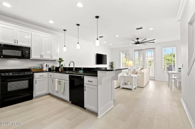 kitchen with white cabinetry, ceiling fan, sink, pendant lighting, and black appliances