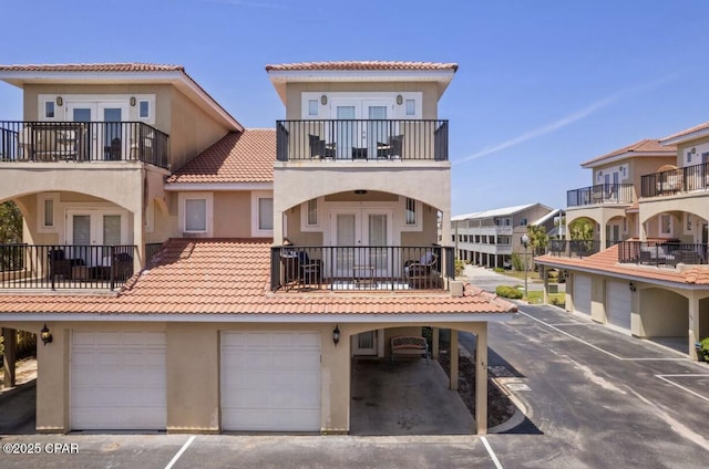 rear view of property with french doors and a garage