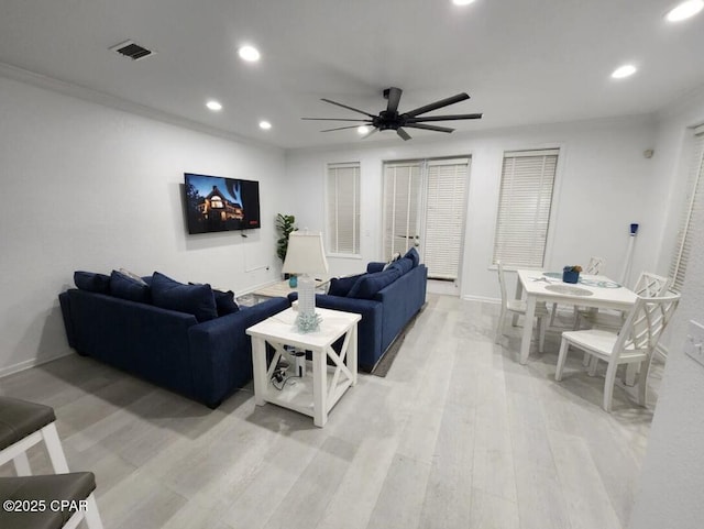 living room with ceiling fan and light hardwood / wood-style floors