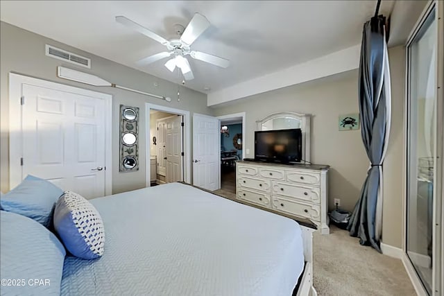 carpeted bedroom featuring ensuite bath and ceiling fan