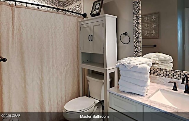 bathroom with vanity, a shower with shower curtain, and toilet