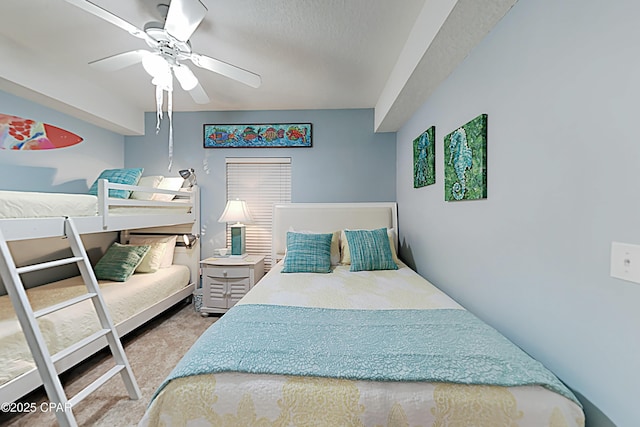 bedroom featuring ceiling fan, carpet floors, and a textured ceiling