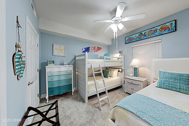 bedroom with light carpet and ceiling fan