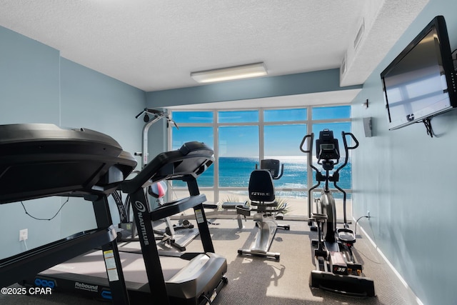 workout room with a textured ceiling