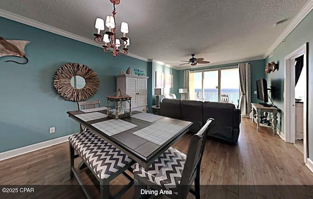 dining room featuring hardwood / wood-style flooring, crown molding, a textured ceiling, and an inviting chandelier