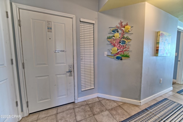 entrance foyer with light tile patterned floors and baseboards