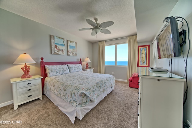 bedroom featuring light carpet, ceiling fan, baseboards, and a textured ceiling