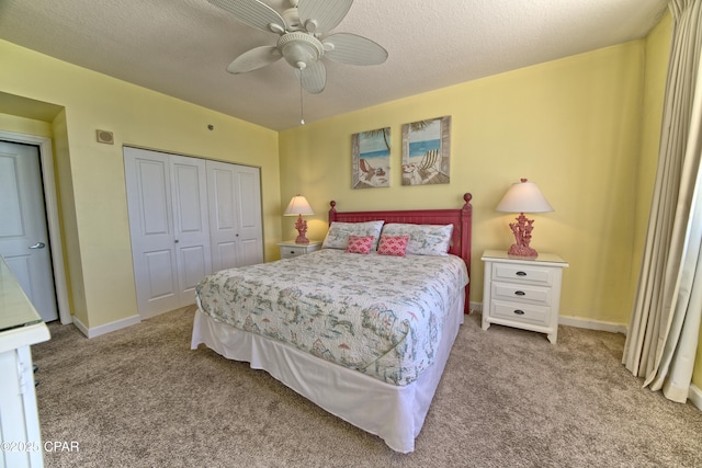 bedroom with light carpet, a textured ceiling, a closet, and ceiling fan