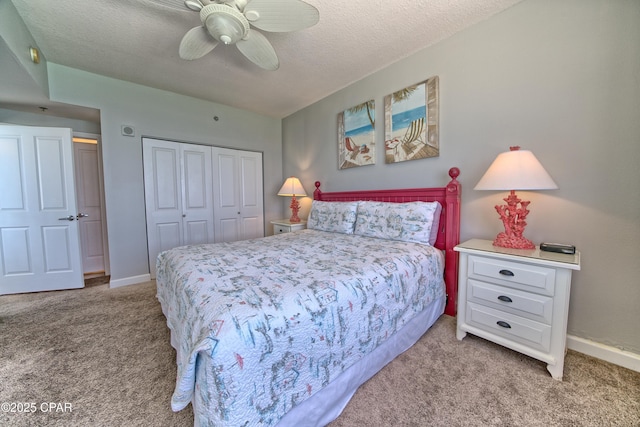 carpeted bedroom with a closet, baseboards, a ceiling fan, and a textured ceiling
