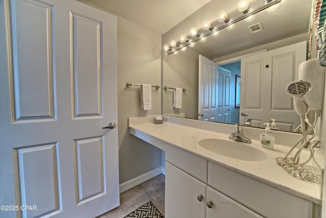 bathroom with visible vents, baseboards, tile patterned flooring, and vanity