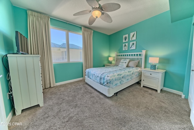 bedroom with baseboards, a textured ceiling, and carpet floors