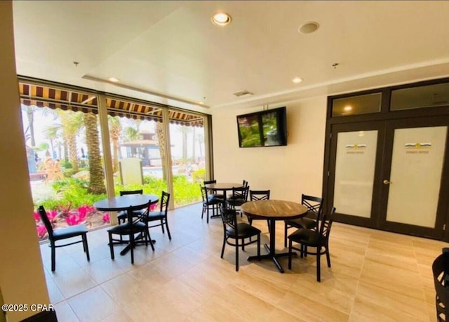 dining space with french doors, light tile patterned floors, and recessed lighting