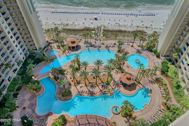 drone / aerial view featuring a view of the beach and a water view