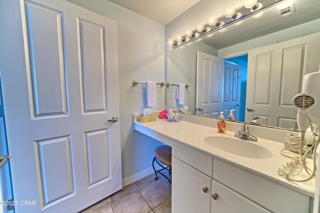 bathroom featuring tile patterned floors, vanity, and baseboards