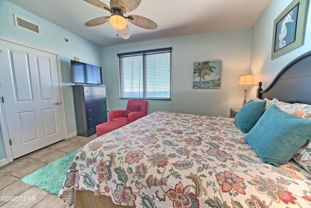 tiled bedroom featuring visible vents, baseboards, and a ceiling fan