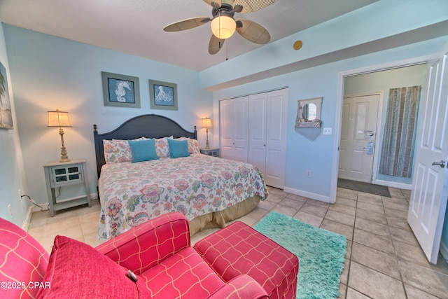 bedroom with a closet, baseboards, ceiling fan, and light tile patterned floors