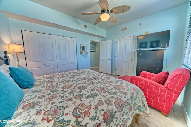 tiled bedroom with ceiling fan