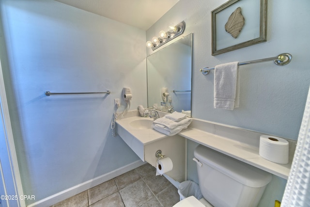 bathroom with toilet, tile patterned floors, vanity, and baseboards