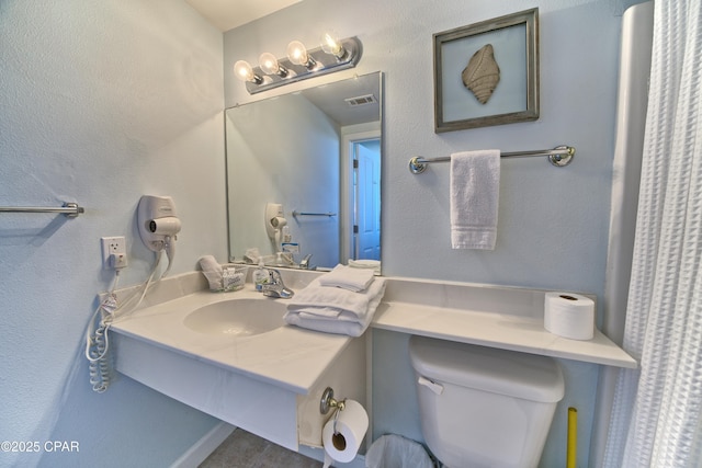 full bath with visible vents, toilet, and vanity