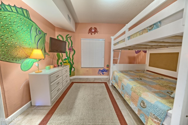tiled bedroom with visible vents, baseboards, and a textured ceiling