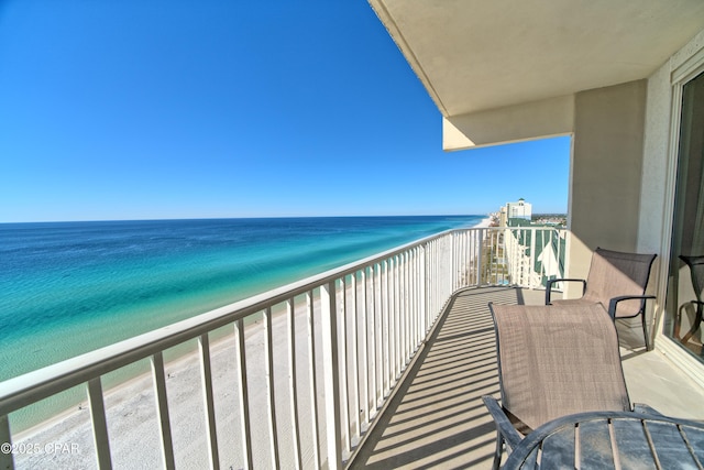balcony with a beach view and a water view