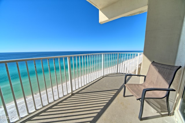 balcony with a water view and a beach view