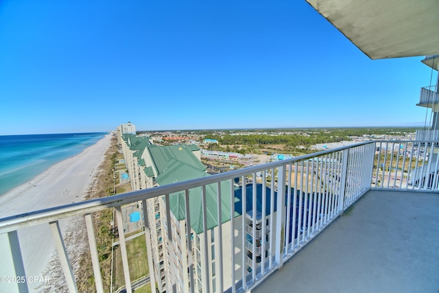 balcony with a water view and a beach view