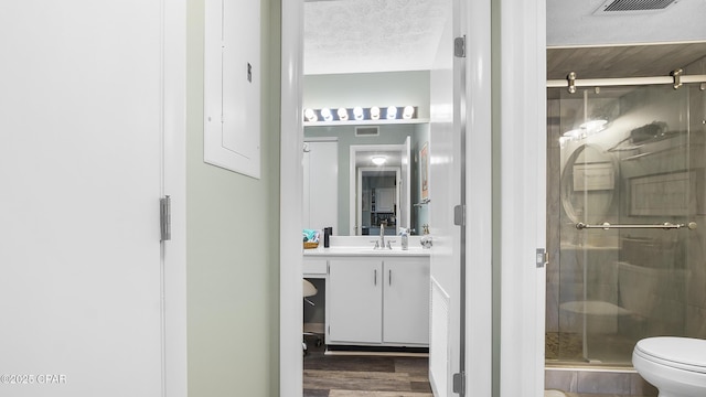 4271 Kingfish Ln Unit 271, Panama City Beach, FL 32408 - full bath featuring a shower stall, vanity, toilet, visible vents, and wood finished floors