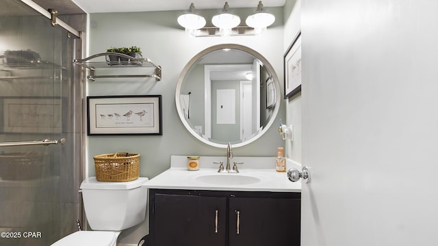 bathroom with vanity, toilet, and walk in shower