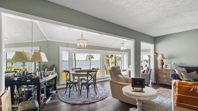 interior space with a notable chandelier, hardwood / wood-style flooring, a textured ceiling, and a water view