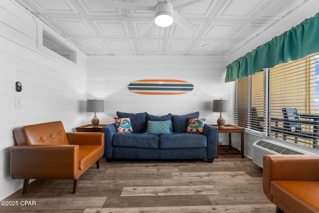 living room featuring an AC wall unit and hardwood / wood-style floors