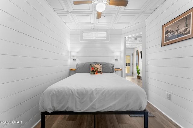 bedroom featuring coffered ceiling, ceiling fan, and hardwood / wood-style floors