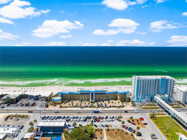 birds eye view of property featuring a water view and a beach view