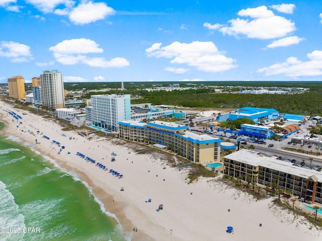 drone / aerial view featuring a water view and a beach view