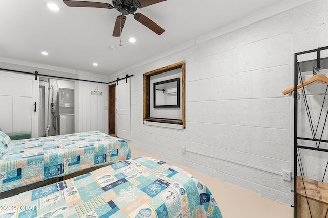 bedroom featuring a barn door, a ceiling fan, and recessed lighting