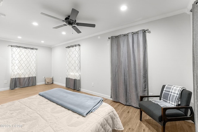 bedroom featuring light wood-style floors, baseboards, and crown molding