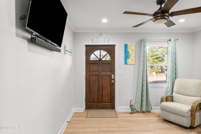 foyer featuring baseboards, ornamental molding, recessed lighting, and light wood-style floors