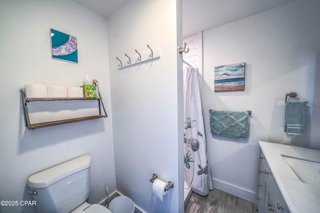 bathroom featuring hardwood / wood-style floors, vanity, and toilet