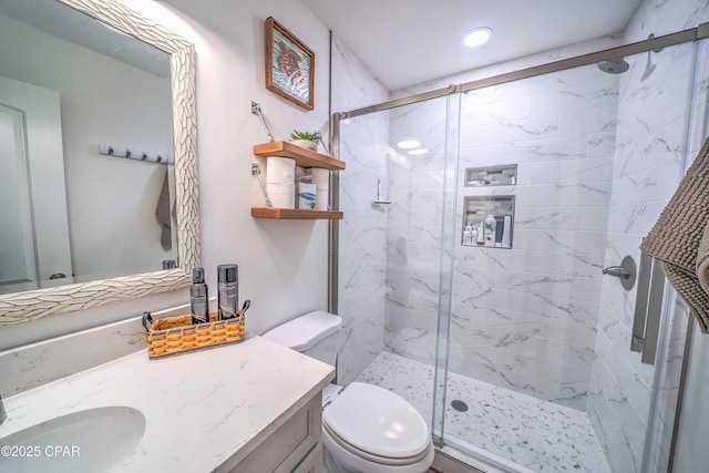 bathroom with vanity, toilet, and an enclosed shower