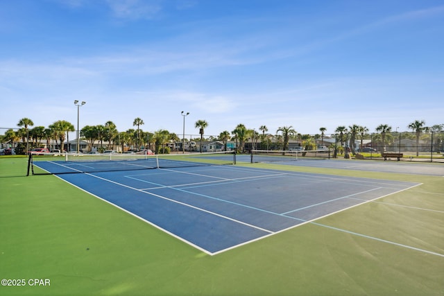 view of tennis court featuring basketball hoop