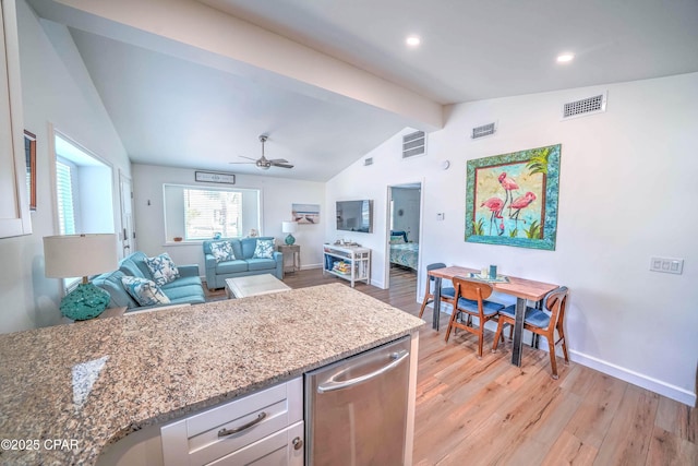 kitchen featuring stone counters, ceiling fan, lofted ceiling with beams, light hardwood / wood-style floors, and white cabinets