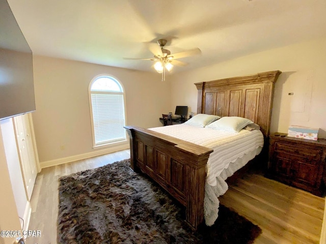 bedroom with light hardwood / wood-style flooring and ceiling fan